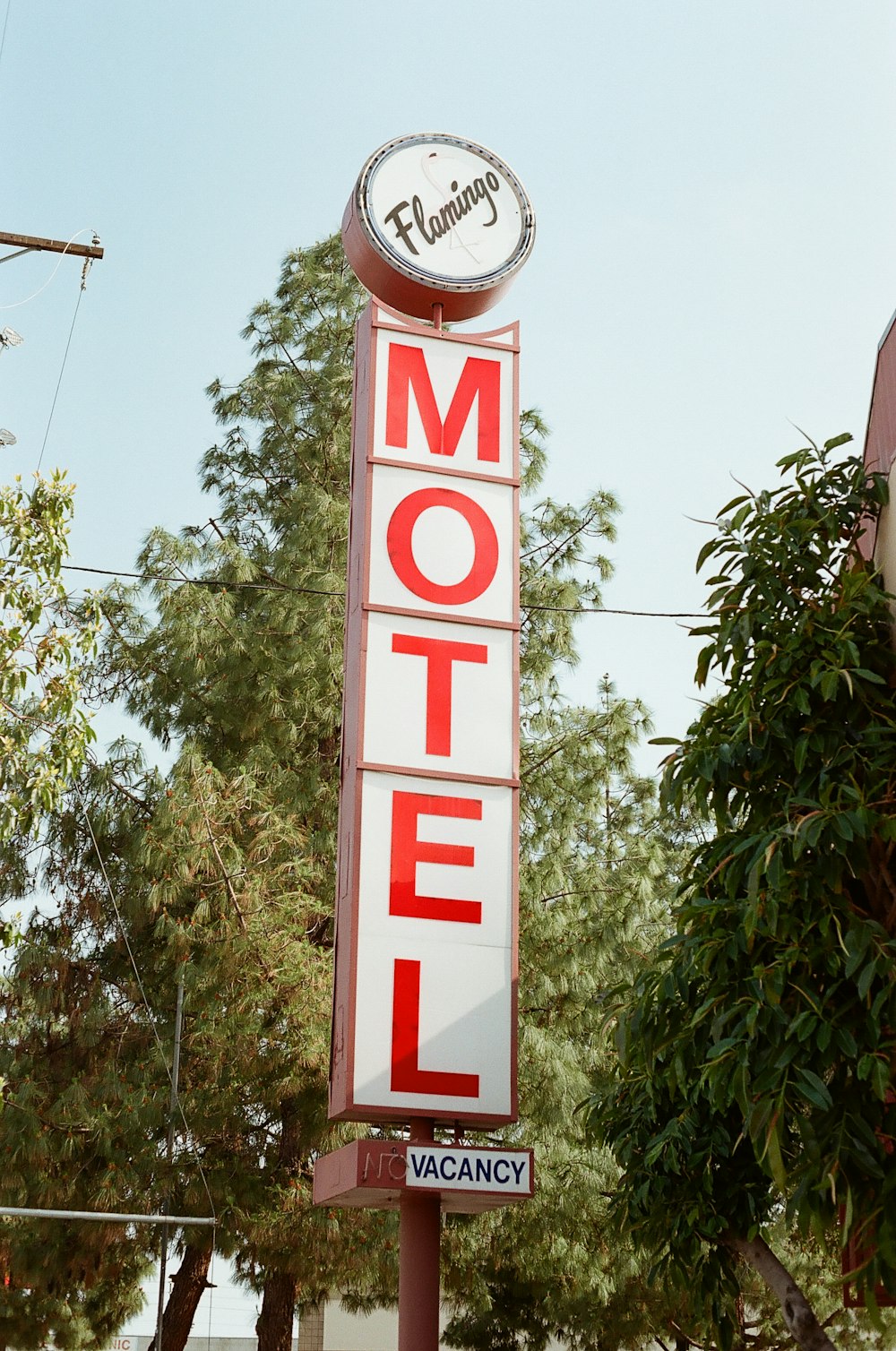 a motel sign with a clock on top of it