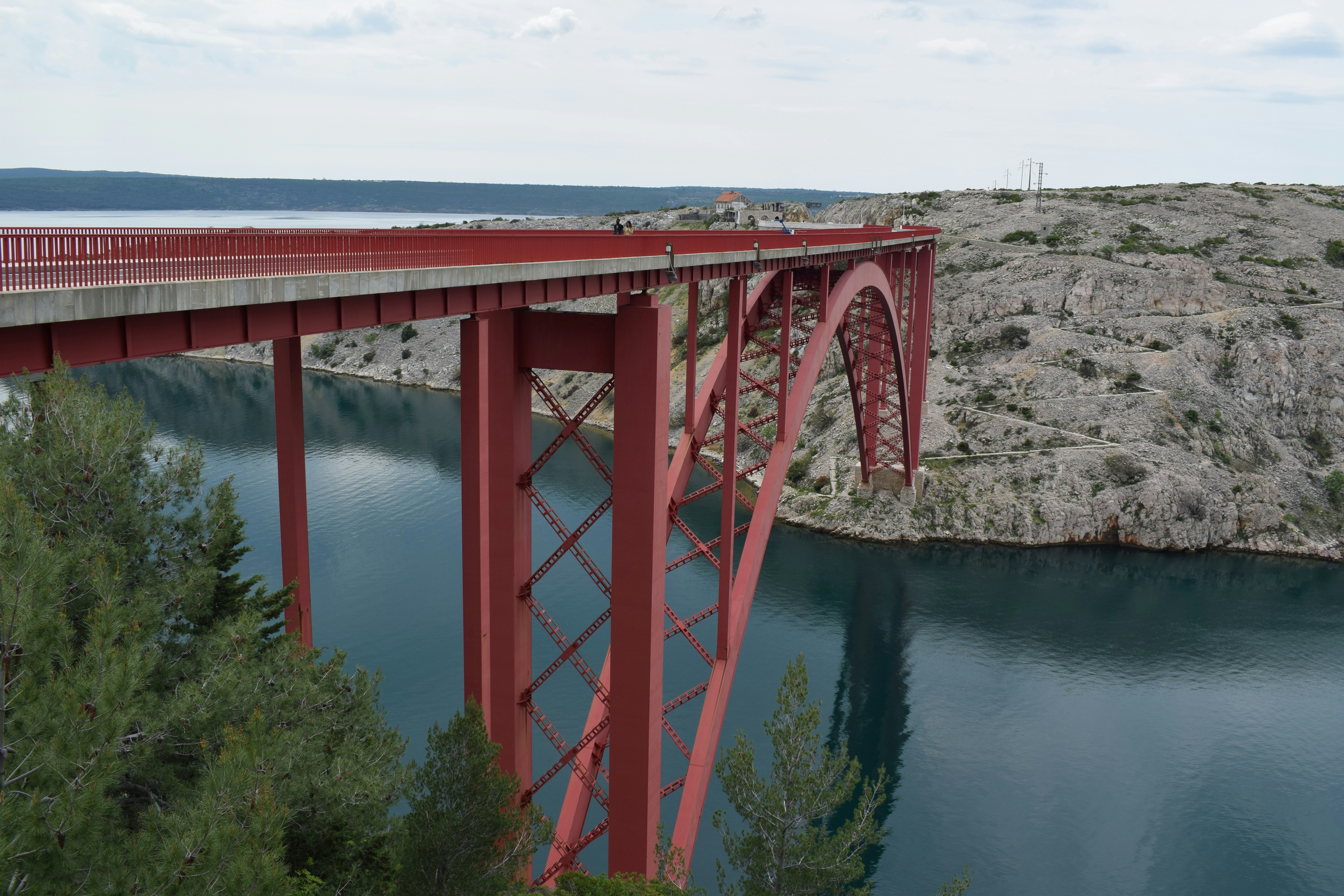 a red bridge over a large body of water