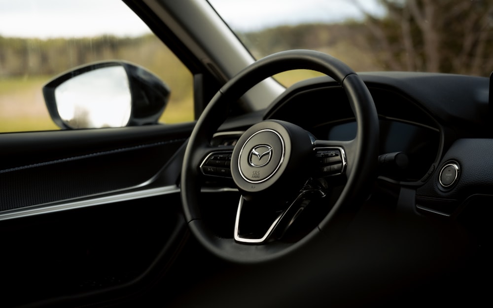 the interior of a car with a steering wheel and dashboard