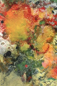 An abstract mix of colors and textures, featuring vibrant reds, yellows, and greens with swirling and textured patterns. The image has an organic, fluid appearance, resembling natural formations or painted surfaces. The use of contrasting colors creates a dynamic and energetic visual effect.