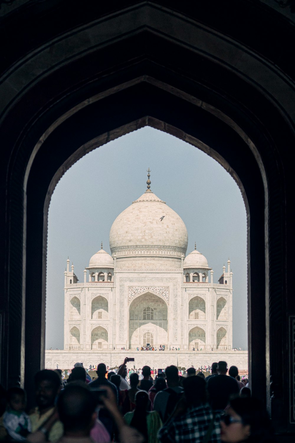 a group of people standing in front of a white building