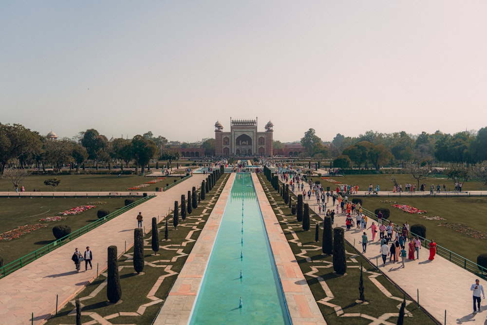 a long pool of water in the middle of a park