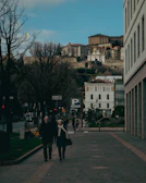 A veteran couple exploring a historic European city, admiring old architecture.