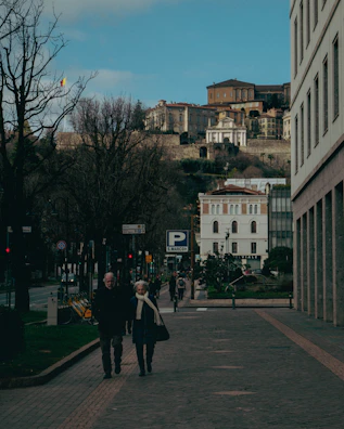 A veteran couple exploring a historic European city, admiring old architecture.
