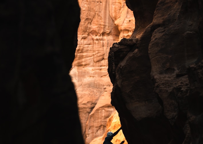 a man climbing up the side of a cliff