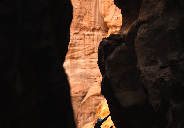 a man climbing up the side of a cliff