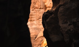 a man climbing up the side of a cliff