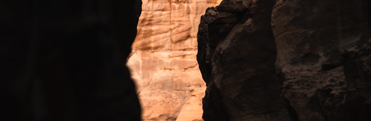 a man climbing up the side of a cliff