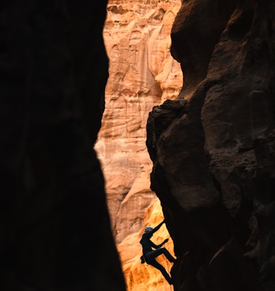 a man climbing up the side of a cliff