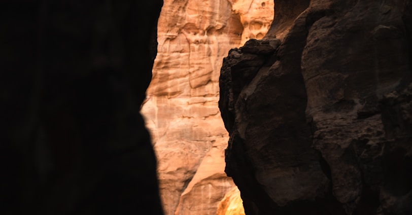 a man climbing up the side of a cliff