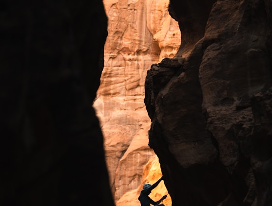 a man climbing up the side of a cliff