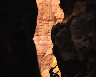 a man climbing up the side of a cliff