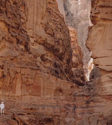 a person standing in a narrow canyon between two mountains