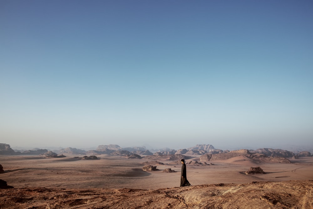 a person standing in the middle of a desert