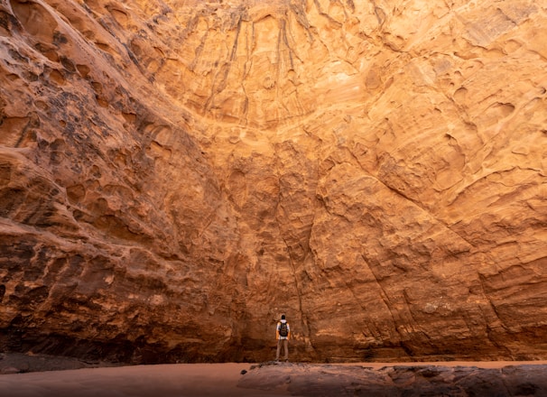 a man standing in the middle of a canyon