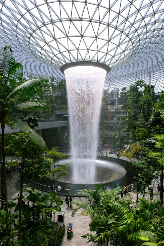 a large waterfall in the middle of a tropical garden
