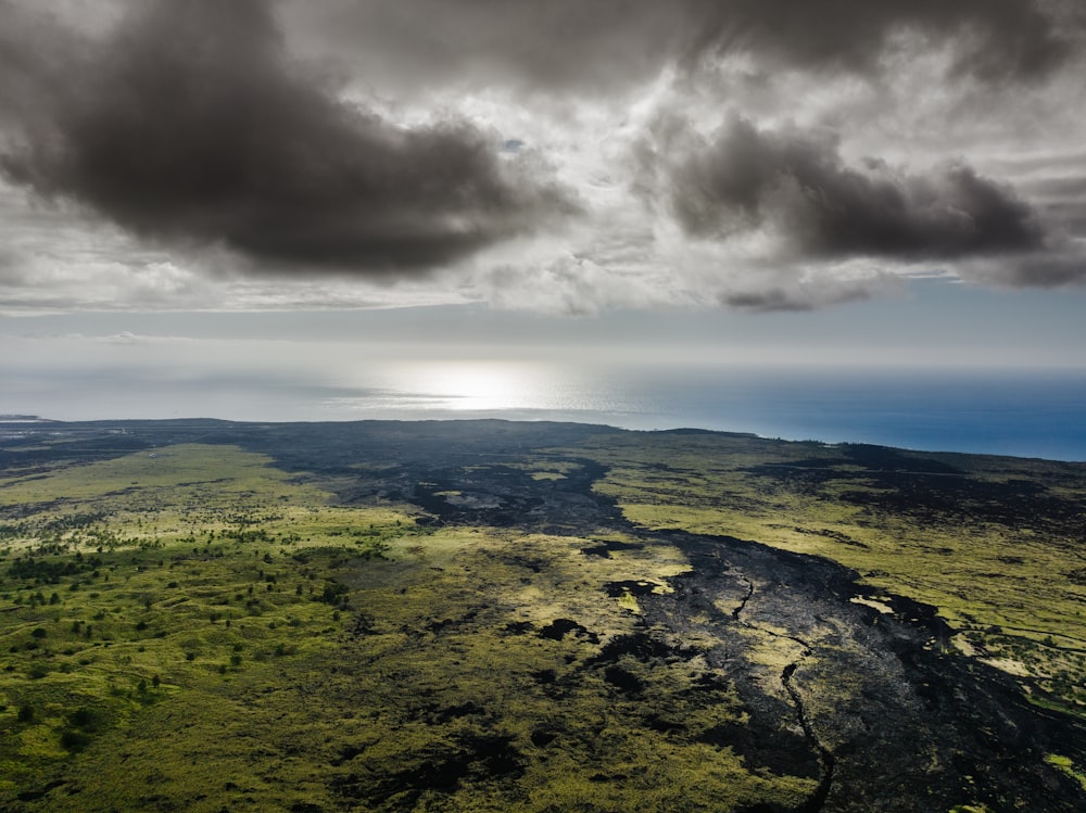 an aerial view of a large body of water under a cloudy sky