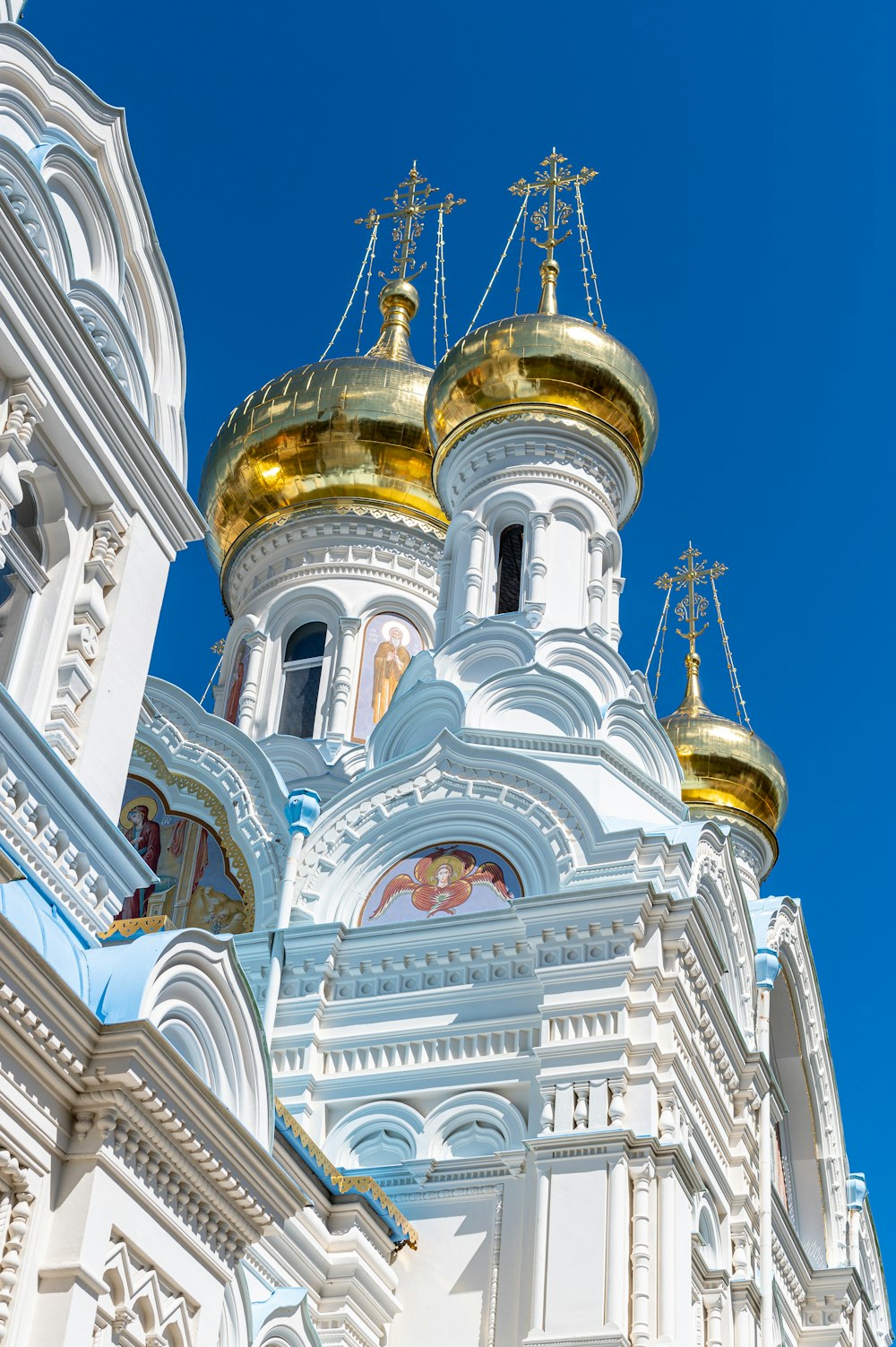 a large white building with gold domes on top