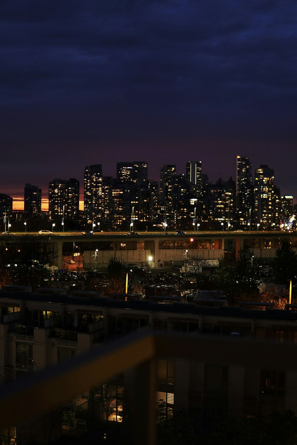 a view of a city at night from a balcony