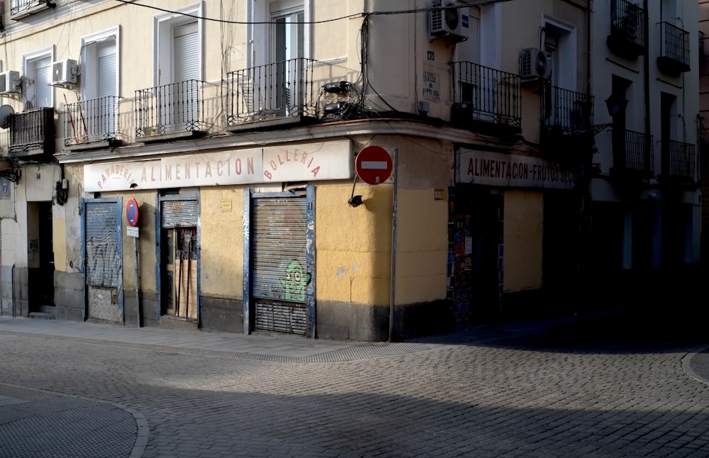 a street corner with a stop sign in front of a building