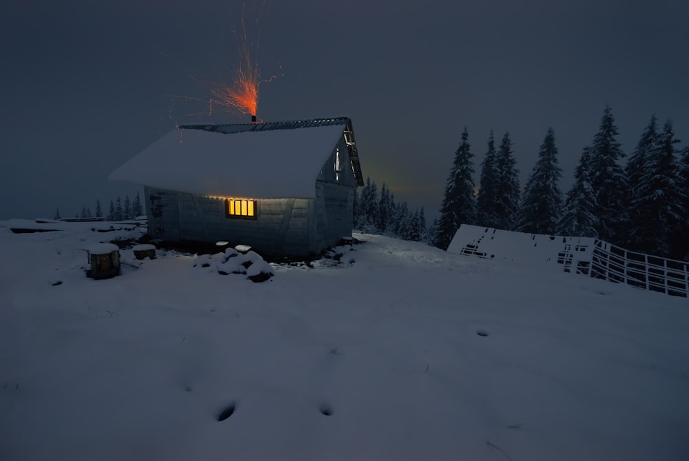 a house in the middle of a snowy field