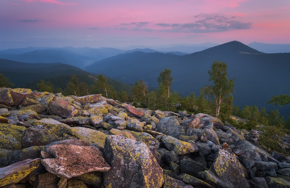 a view of the mountains from a rocky outcropping