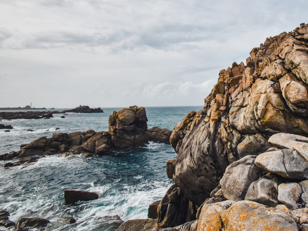 a rocky coast with a large body of water