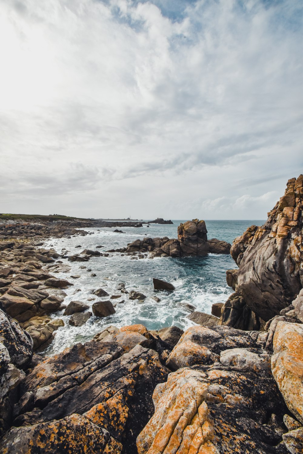 a rocky shore with a body of water