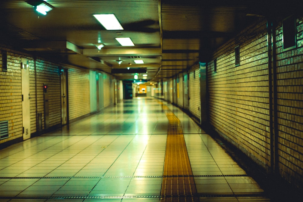 a long hallway with a tiled floor and walls