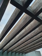 A sturdy wooden roof truss constructed from natural timber beams.