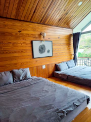 Bedroom corner showcasing plush bedding and warm wood panel accents in executive suite.