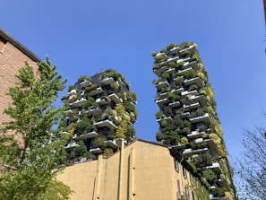 Close-up of sleek condo buildings in downtown Portland with lush greenery.