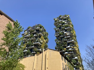Photo of a modern condominium with greenery and clear skies representing sustainable management.