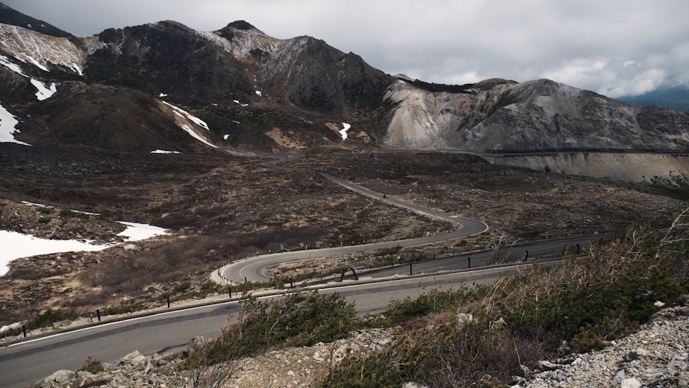 a winding road in the middle of a mountain range