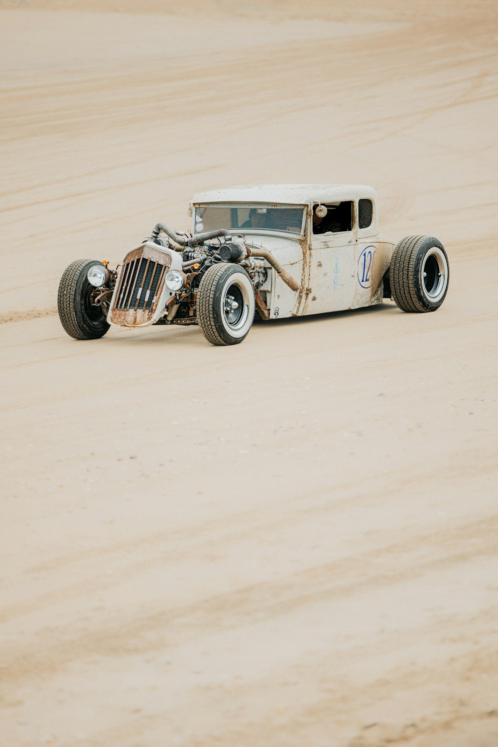 an old model t car in the middle of a desert