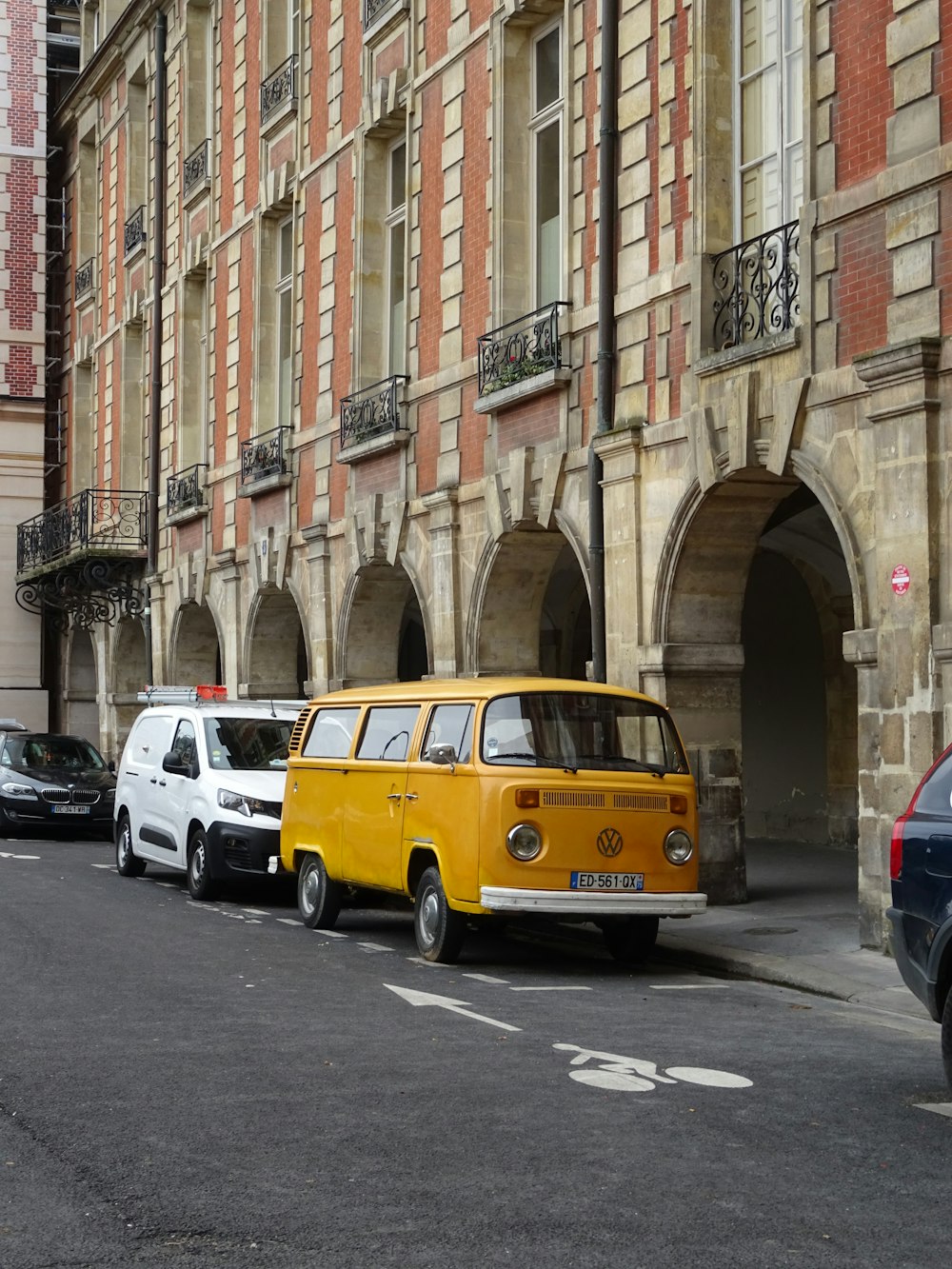 a yellow van is parked in front of a building