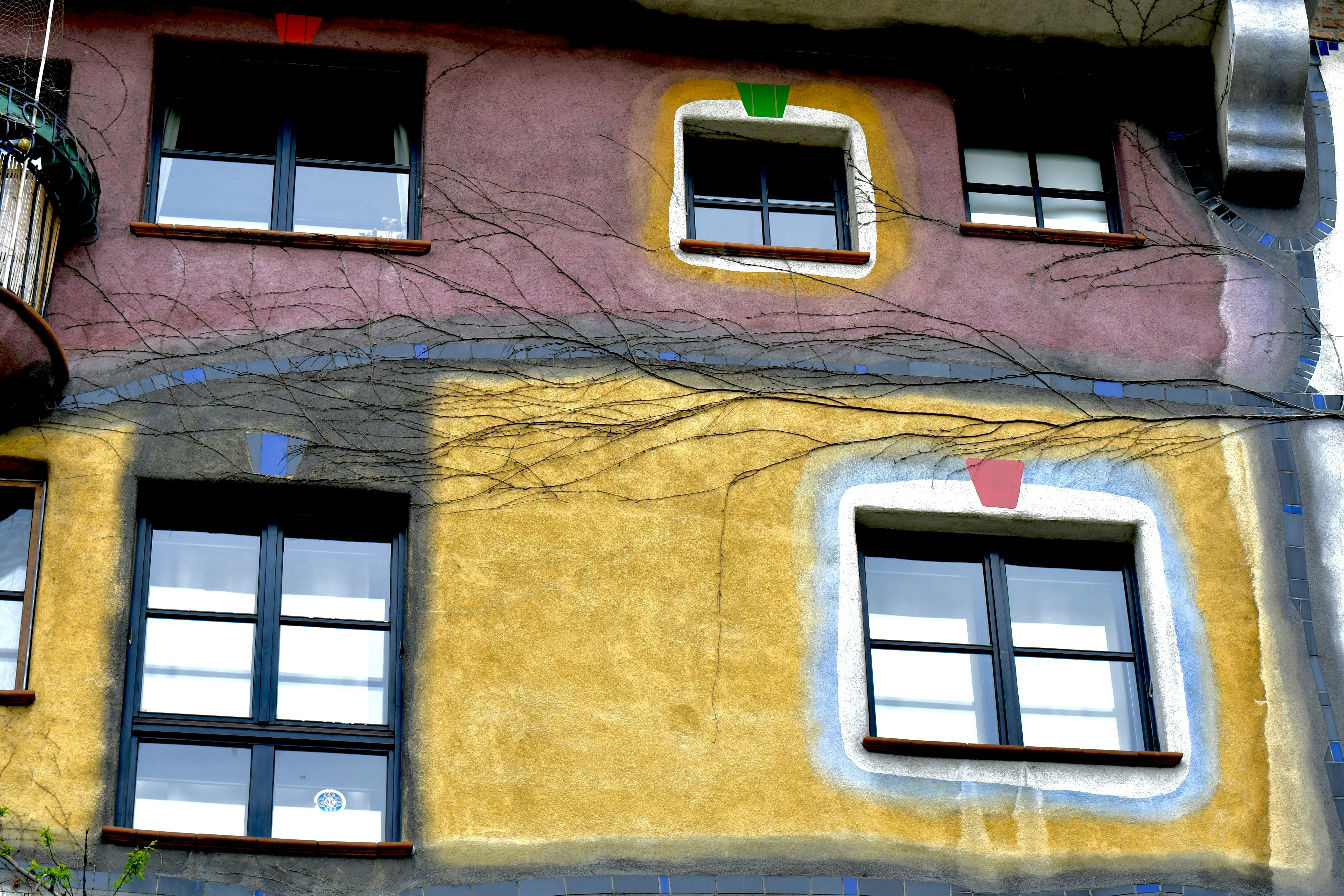 a multicolored building with a clock on the side of it