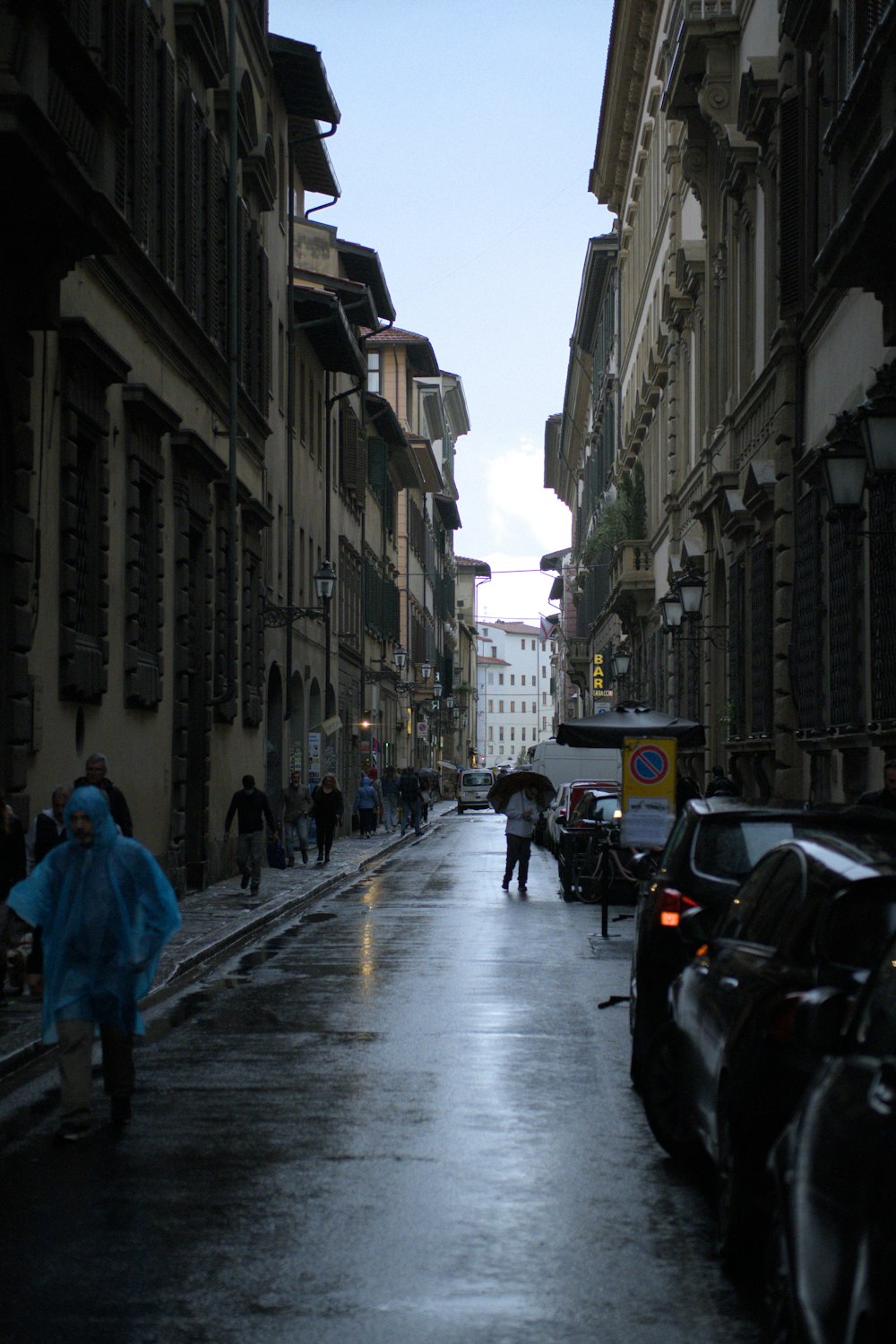 a person walking down a street holding an umbrella