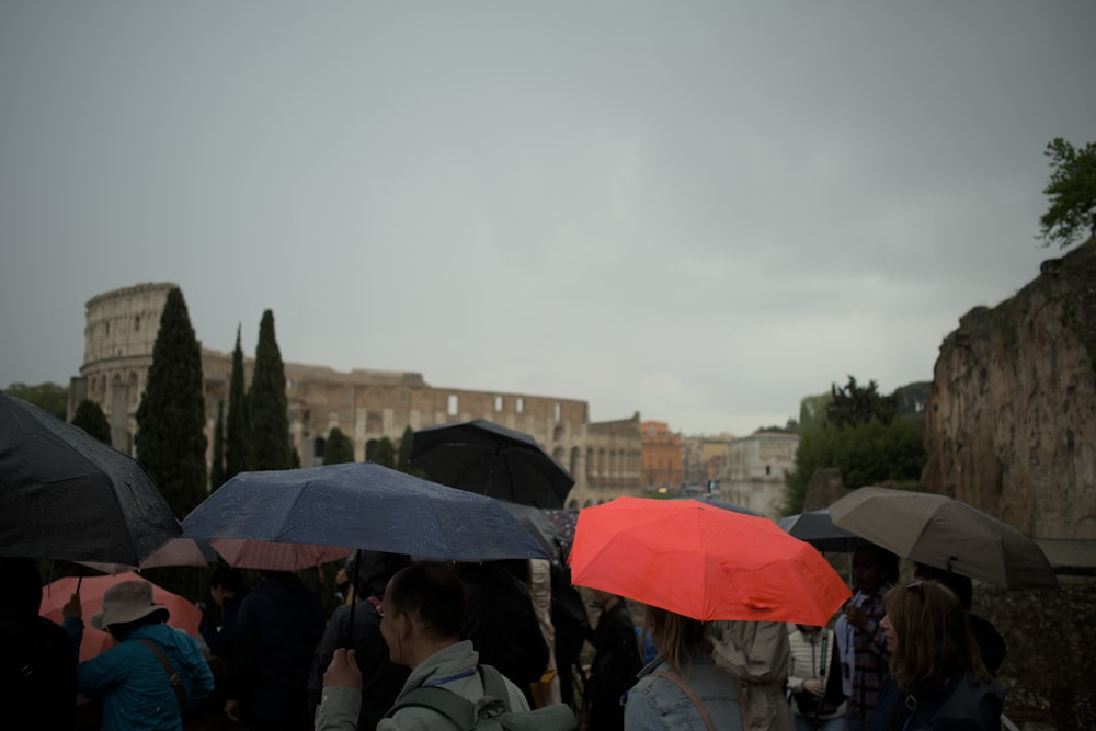 a group of people holding umbrellas in the rain