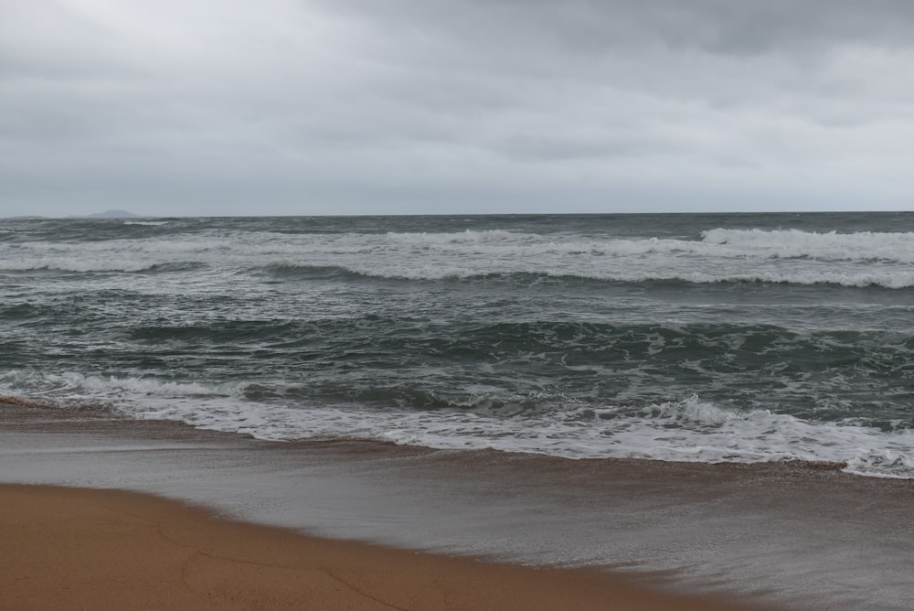 a body of water with waves coming in to shore