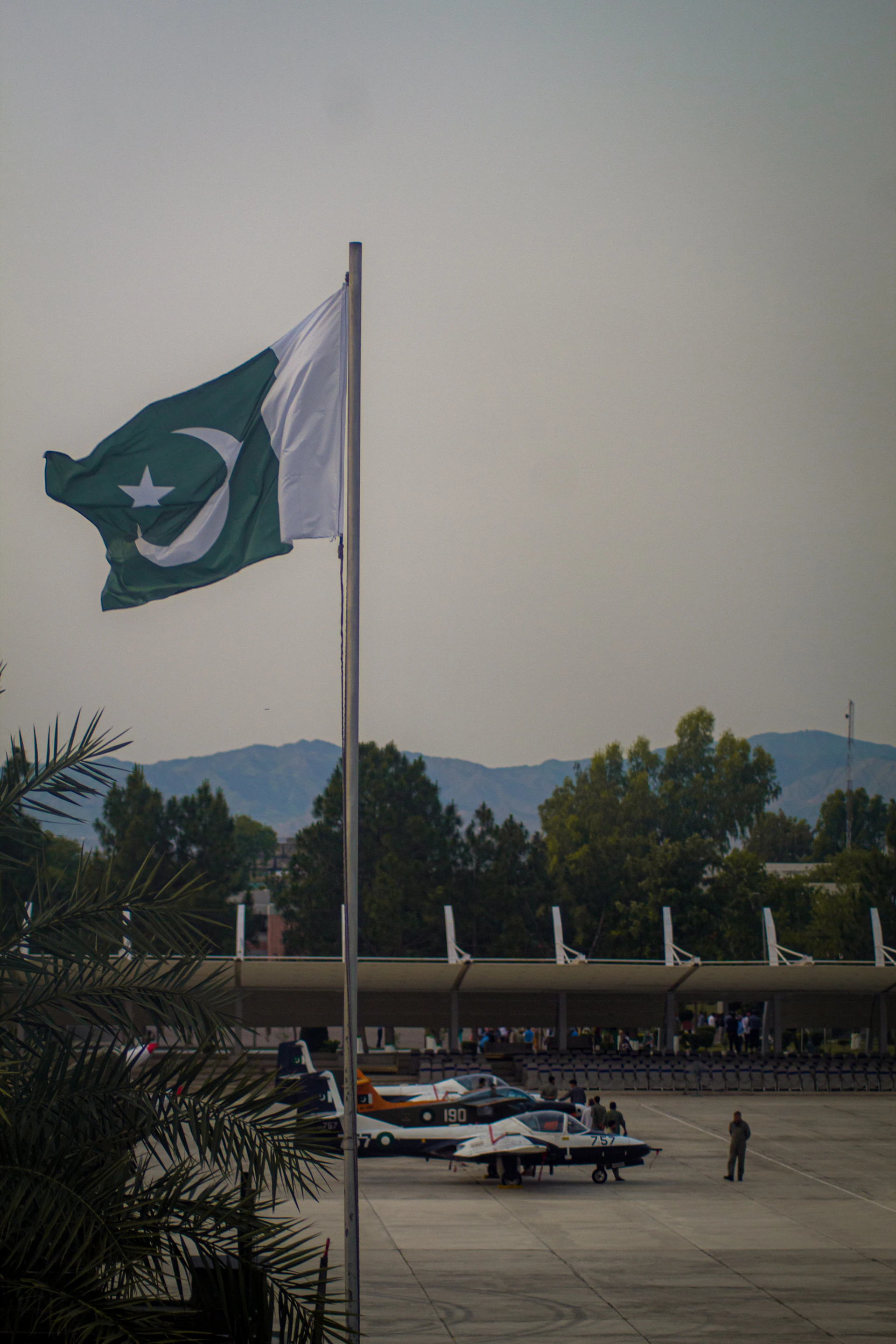a flag flying in the air next to a flag pole