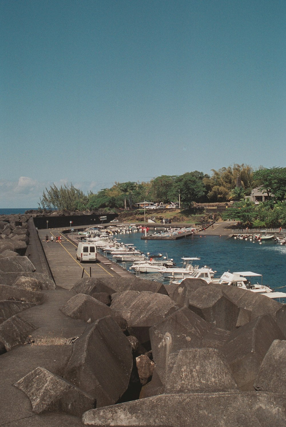 a group of boats parked on the shore of a body of water