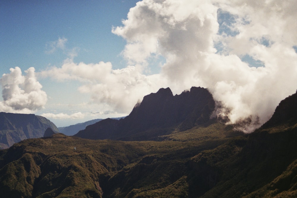 a view of a mountain range with clouds in the sky