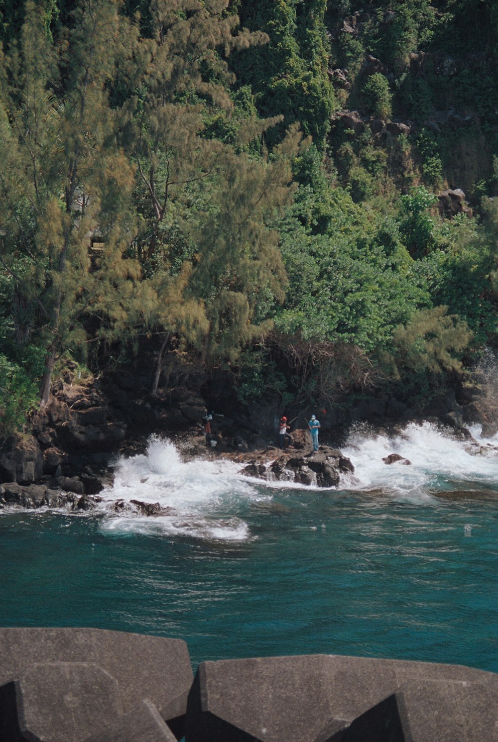 a man standing on a rock in the middle of a river