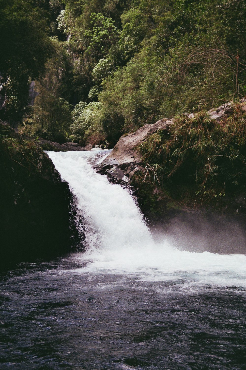 a small waterfall in the middle of a river