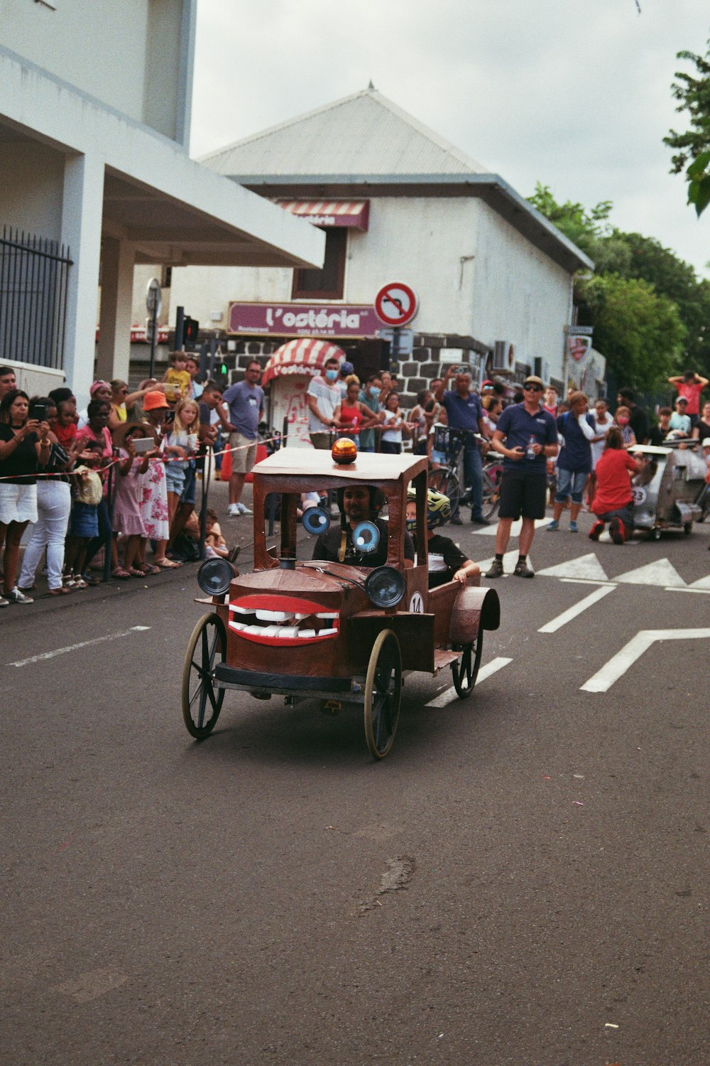 a parade with cars and people on the street