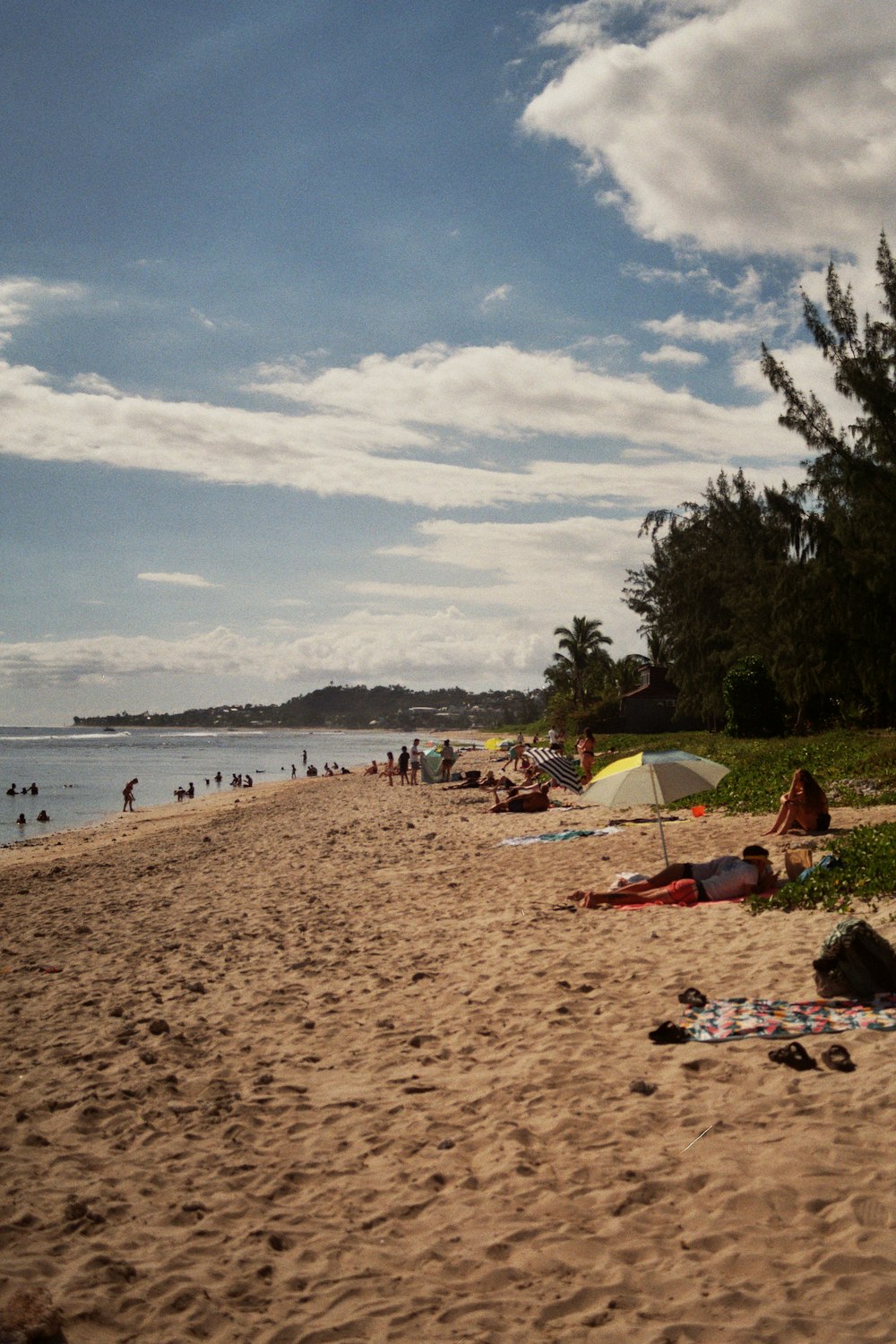 a beach filled with lots of people and umbrellas