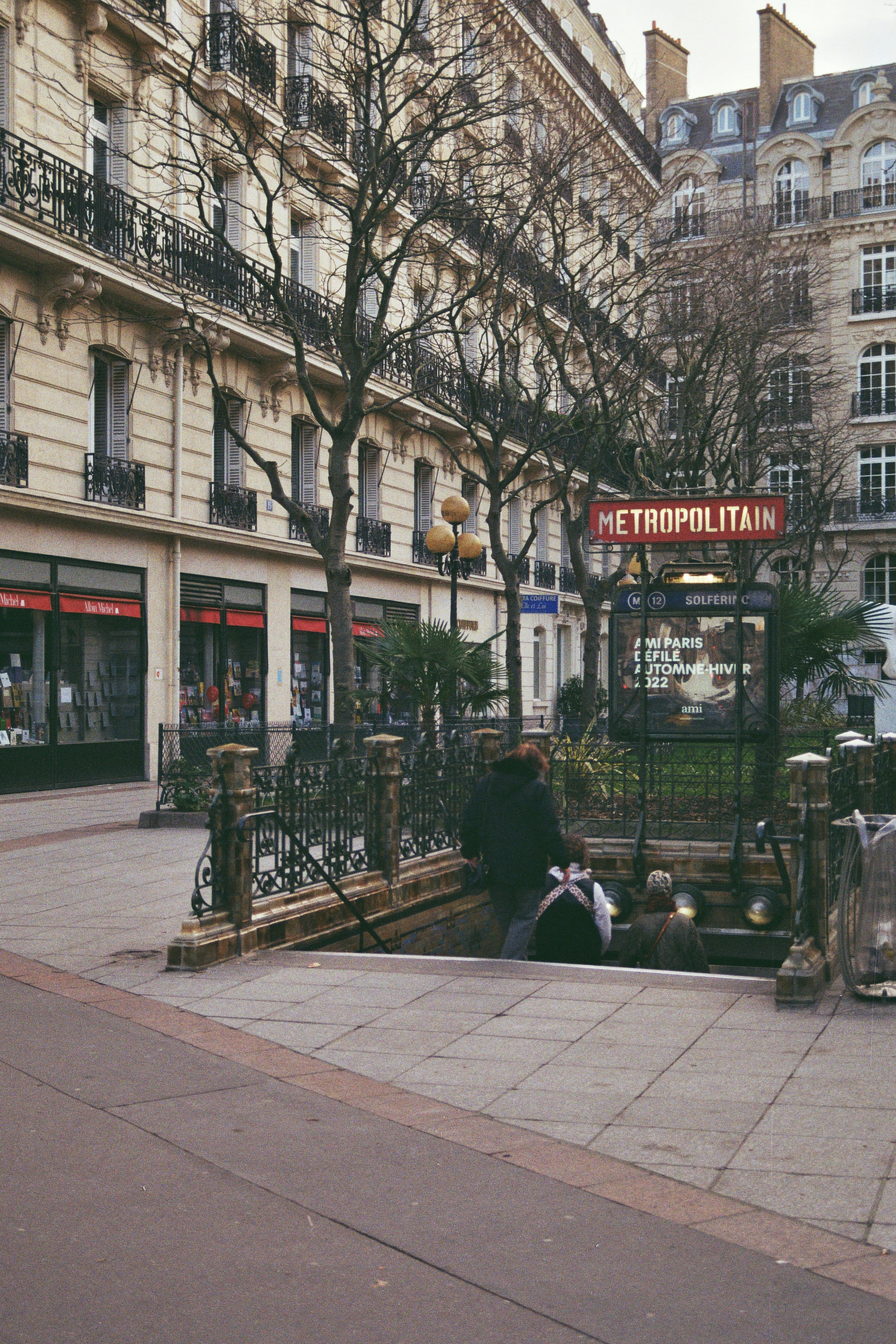 a person sitting on a bench in front of a building
