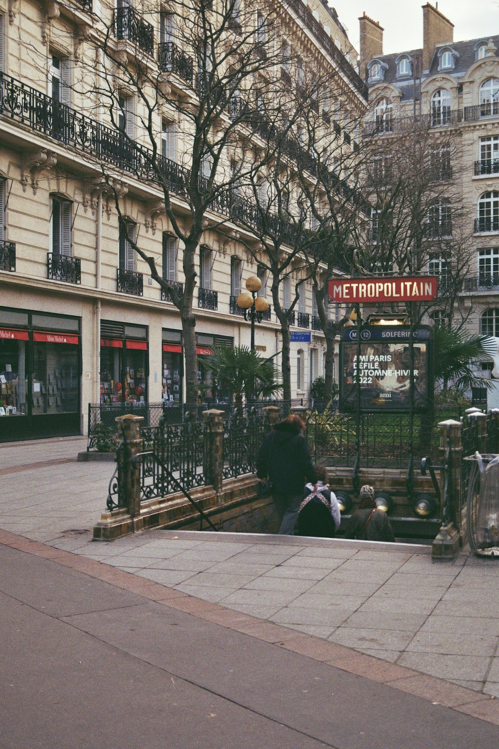 a person sitting on a bench in front of a building