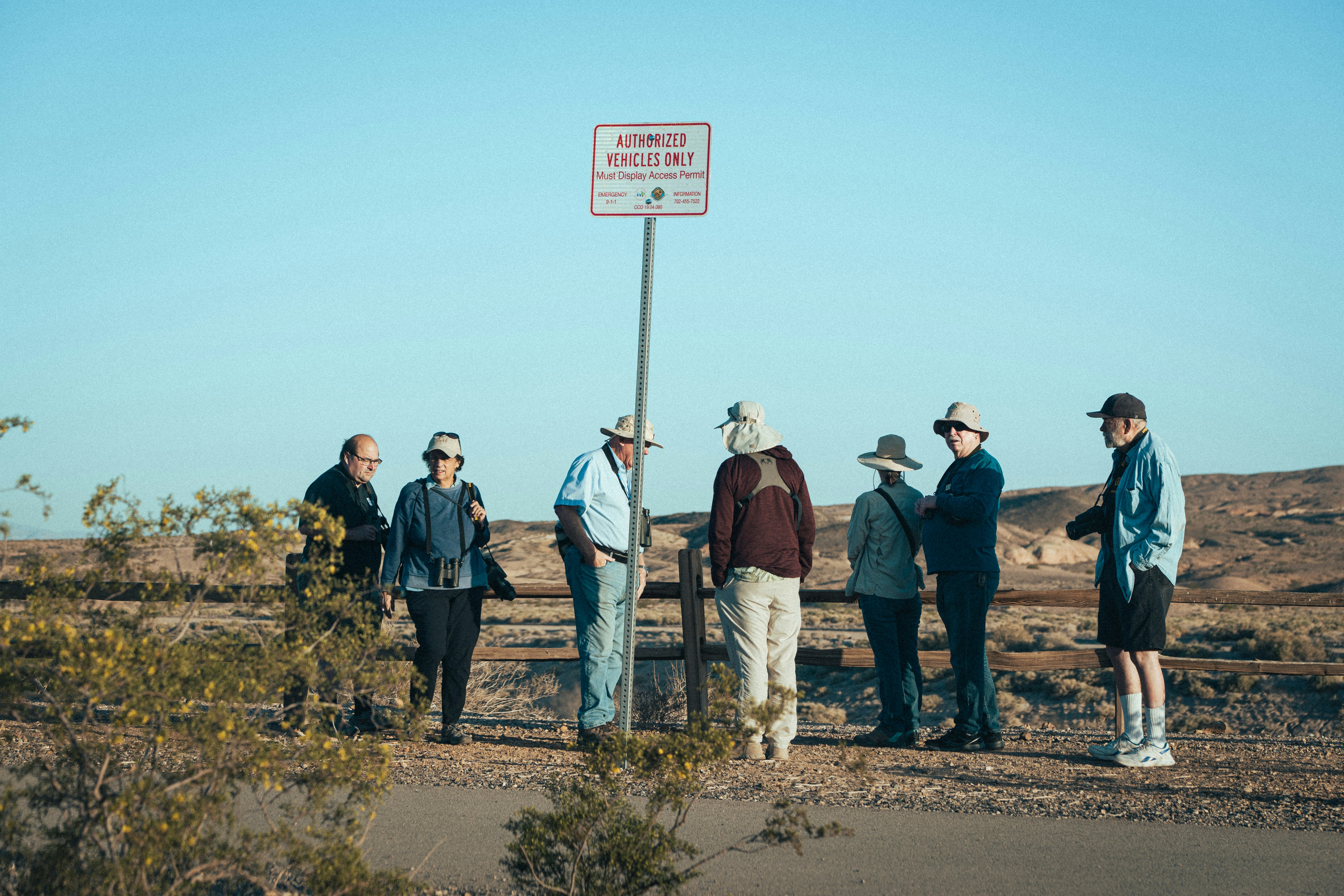 A group of people standing next to a street sign - historical markers near me